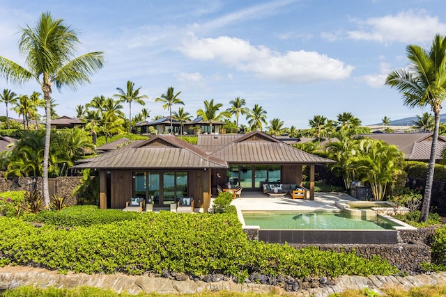73-6250 Alani Loop Unit 12, Kailua-Kona, HI 96740 - rear view of house featuring an outdoor living space, a patio area, a standing seam roof, and french doors