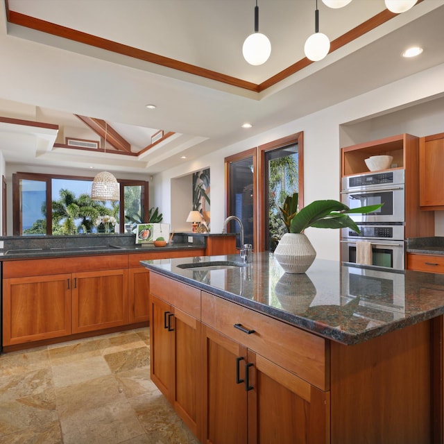81-6641 Auamo Pl, Kealakekua, HI 96750 - kitchen with a sink, a raised ceiling, stainless steel double oven, brown cabinets, and a kitchen island with sink