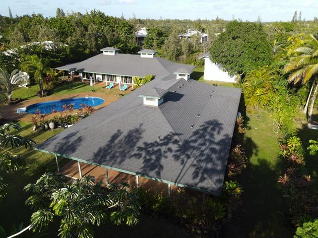 15-1050 Kiawe Rd, Keaau, HI 96749 - aerial view of property and surrounding area featuring a pool and a forest