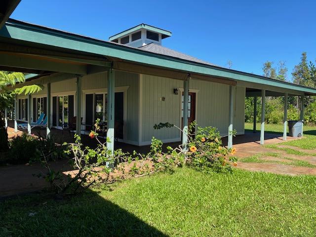 15-1050 Kiawe Rd, Keaau, HI 96749 - rear view of house with a yard