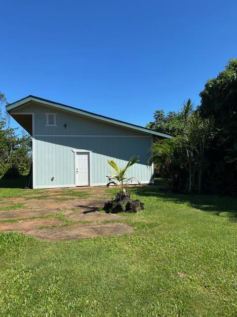 15-1050 Kiawe Rd, Keaau, HI 96749 - view of home's exterior with a yard