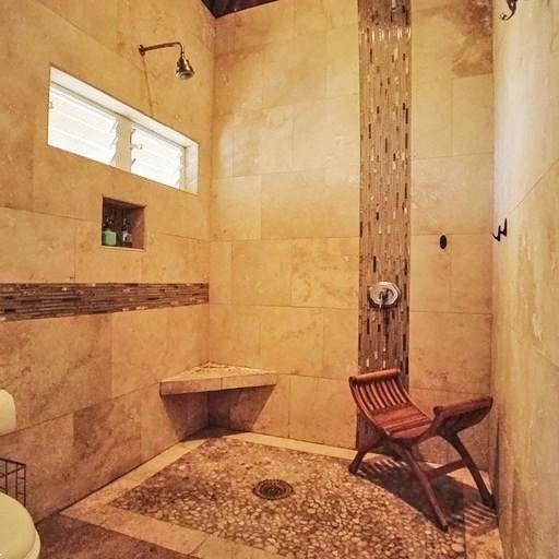 15-1050 Kiawe Rd, Keaau, HI 96749 - bathroom featuring toilet and tile walls