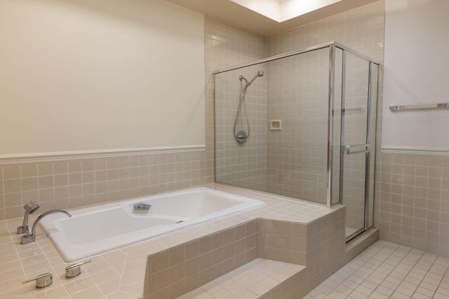 68-1375 Pauoa Rd Unit J2, Kamuela, HI 96743 - bathroom featuring a stall shower, a bath, tile walls, a wainscoted wall, and tile patterned floors