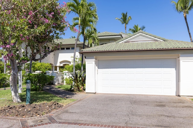 68-1375 Pauoa Rd Unit J2, Kamuela, HI 96743 - view of front of house featuring a tile roof, asphalt driveway, an attached garage, and stucco siding