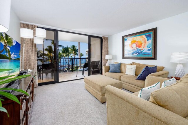 75-6106 Alii Dr Unit 311, Kailua-Kona, HI 96740 - living room featuring a wall of windows and carpet floors