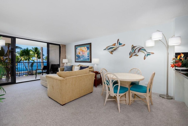 75-6106 Alii Dr Unit 311, Kailua-Kona, HI 96740 - living room with a wall of windows and carpet