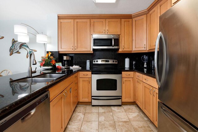 75-6106 Alii Dr Unit 311, Kailua-Kona, HI 96740 - kitchen featuring stainless steel appliances, a sink, decorative backsplash, and dark stone counters