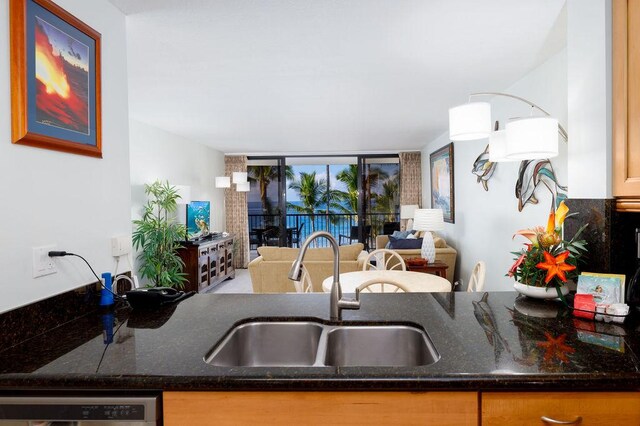 75-6106 Alii Dr Unit 311, Kailua-Kona, HI 96740 - kitchen with a sink, open floor plan, dark stone counters, and dishwashing machine