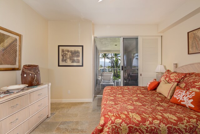 69-1010 Keana Pl Unit E306, Waikoloa, HI 96738 - bedroom featuring access to outside, baseboards, and light stone finish flooring