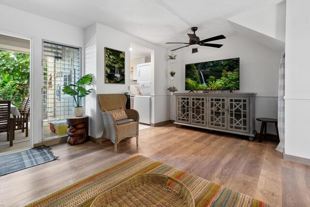 78-6800 Alii Dr Unit 20, Kailua-Kona, HI 96740 - living area with stacked washing machine and dryer, ceiling fan, and wood finished floors