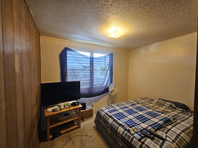 322 Ohai St Unit 2, Hilo, HI 96720 - bedroom featuring carpet floors, a textured ceiling, wood walls, and concrete block wall