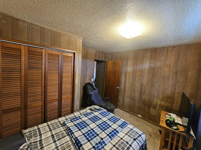 322 Ohai St Unit 2, Hilo, HI 96720 - bedroom with wood walls, a closet, a textured ceiling, and carpet