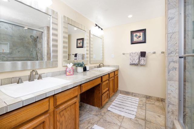 76-6225 Alii Dr Unit 105, Kailua-Kona, HI 96740 - bathroom with double vanity, a stall shower, baseboards, stone tile flooring, and recessed lighting