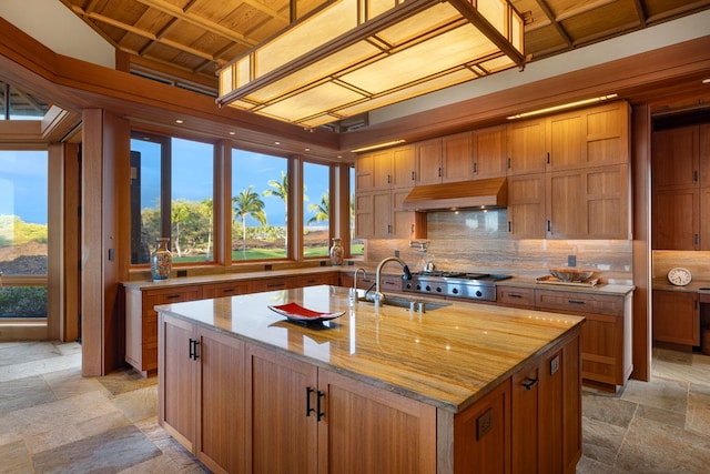 68-1000 Ke Kailani Dr, Kamuela, HI 96743 - kitchen with a sink, custom exhaust hood, tasteful backsplash, stone tile floors, and brown cabinetry