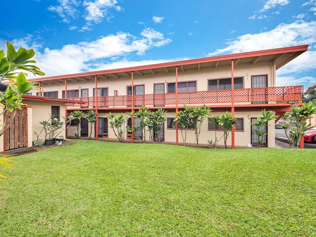 307 Lehua St Unit 22, Hilo, HI 96720 - back of house with stucco siding and a lawn