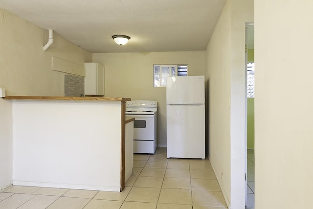 75-156 Lunapule Rd, Kailua-Kona, HI 96740 - kitchen with white appliances, light tile patterned flooring, and white cabinets