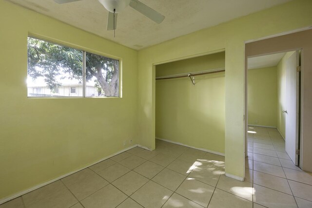 75-156 Lunapule Rd, Kailua-Kona, HI 96740 - unfurnished bedroom featuring light tile patterned floors, a closet, a ceiling fan, and baseboards