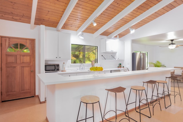 13-3638 Kumakahi St, Pahoa, HI 96778 - kitchen featuring stainless steel appliances, wooden ceiling, a sink, white cabinetry, and a kitchen bar