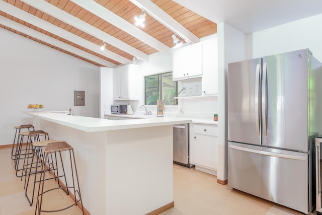 13-3638 Kumakahi St, Pahoa, HI 96778 - kitchen featuring appliances with stainless steel finishes, wood ceiling with exposed beams, white cabinetry, a peninsula, and a breakfast bar
