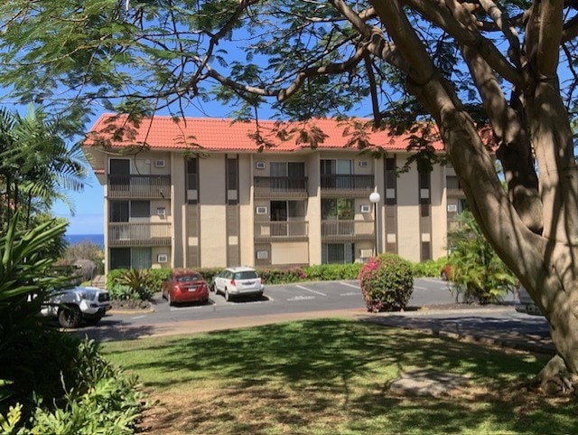 75-5873 Walua Rd Unit 118, Kailua-Kona, HI 96740 - view of building exterior with uncovered parking