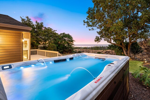68-1942 Lina Poepoe St, Waikoloa, HI 96738 - pool at dusk featuring a hot tub and a wooden deck