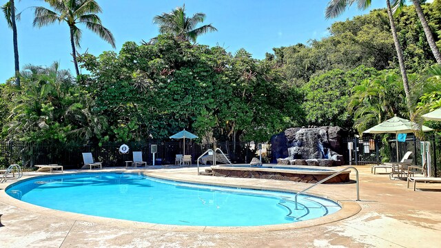 1568 Pee Rd Unit 211, Koloa, HI 96756 - community pool with a patio, a hot tub, and view of scattered trees