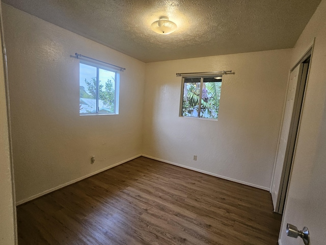 37-A Noio Ln Unit 2, Hilo, HI 96720 - spare room with plenty of natural light, dark wood-style flooring, a textured ceiling, and baseboards