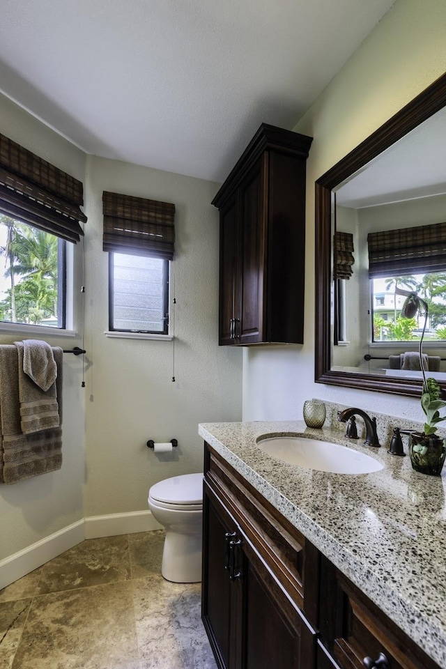 5451 Ka Haku Rd Unit 8, Princeville, HI 96722 - bathroom with vanity, healthy amount of natural light, toilet, and baseboards