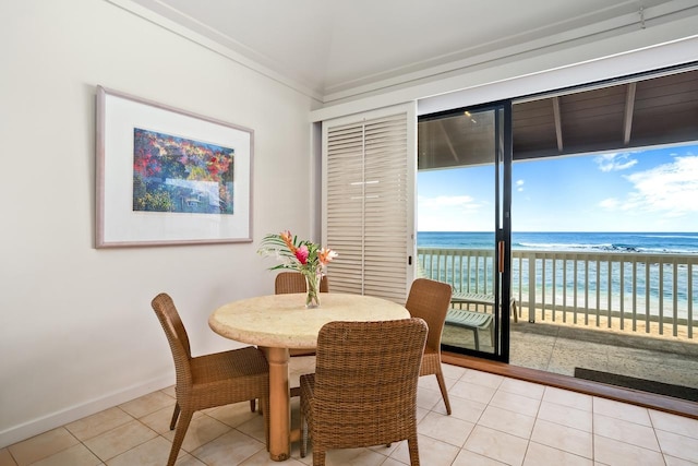 2253 Poipu Rd Unit 2, Koloa, HI 96756 - dining room featuring light tile patterned floors, view of water and beach, and baseboards