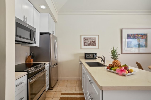 2253 Poipu Rd Unit 2, Koloa, HI 96756 - kitchen featuring stainless steel appliances, a sink, a peninsula, light countertops, and white cabinets