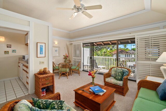 2253 Poipu Rd Unit 77, Koloa, HI 96756 - living room featuring a ceiling fan, light tile patterned floors, ornamental molding, and light colored carpet