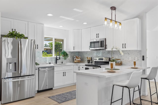 15-1499 23rd Ave, Keaau, HI 96749 - kitchen featuring appliances with stainless steel finishes, a sink, a peninsula, white cabinets, and recessed lighting