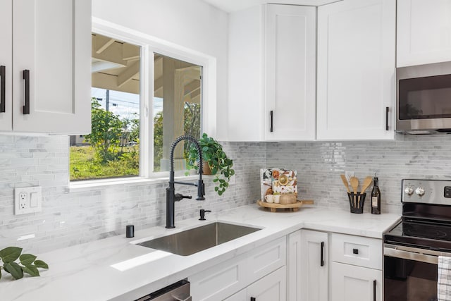 15-1499 23rd Ave, Keaau, HI 96749 - kitchen featuring appliances with stainless steel finishes, a sink, white cabinetry, backsplash, and light stone countertops