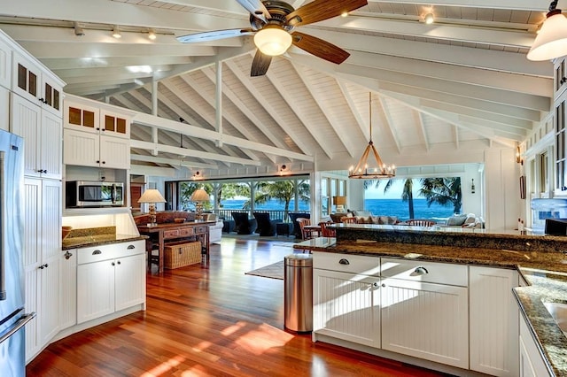 7324 Alealea Rd, Hanalei, HI 96714 - kitchen featuring open floor plan, stainless steel microwave, wooden ceiling, dark wood-type flooring, and track lighting