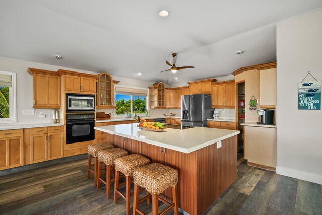 3675 Albert Rd, Princeville, HI 96722 - kitchen with appliances with stainless steel finishes, light countertops, glass insert cabinets, a center island, and dark wood-type flooring