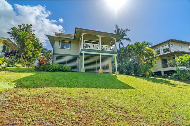 3675 Albert Rd, Princeville, HI 96722 - rear view of house featuring a lawn and a balcony