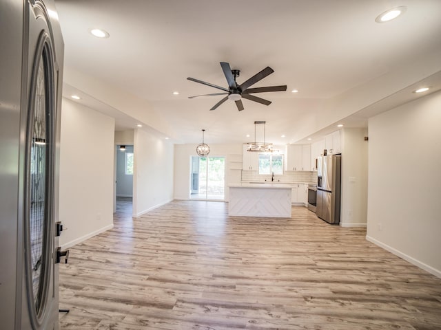 15-1703 5th Ave, Keaau, HI 96749 - unfurnished living room featuring light wood-style floors, recessed lighting, a ceiling fan, baseboards, and a sink
