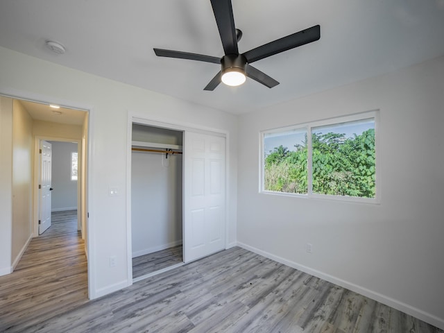 15-1703 5th Ave, Keaau, HI 96749 - unfurnished bedroom with wood finished floors, baseboards, a closet, and a ceiling fan