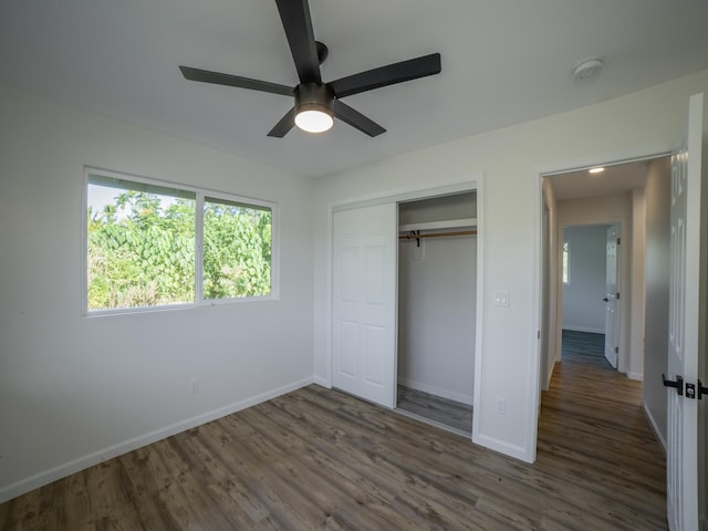 15-1703 5th Ave, Keaau, HI 96749 - unfurnished bedroom featuring baseboards, dark wood finished floors, a closet, and a ceiling fan