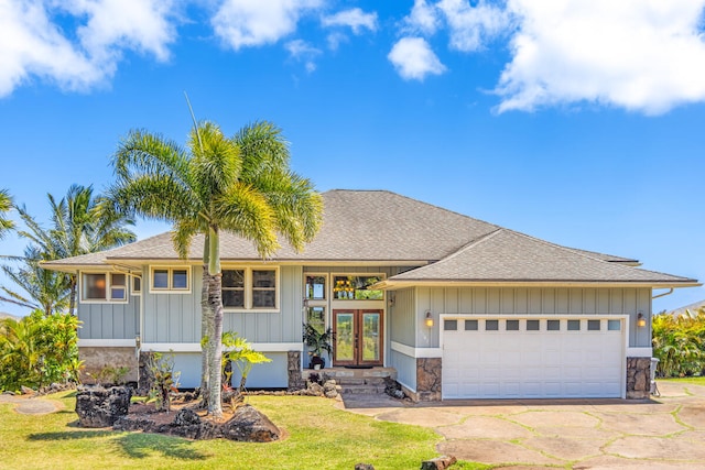 1167 Pua Melia St, Kalaheo, HI 96741 - view of front of home featuring french doors, a garage, a front yard, roof with shingles, and stone siding