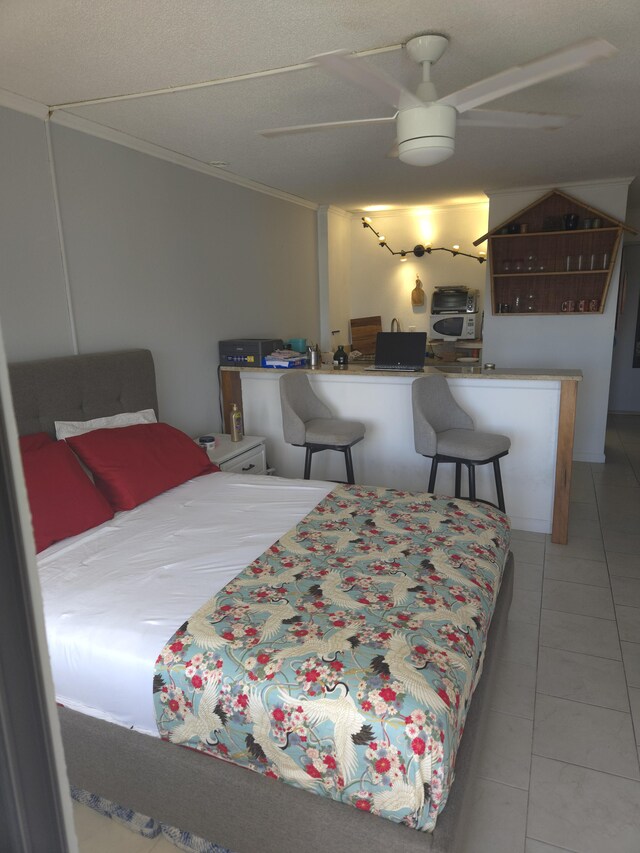 75-5680 Kuakini Hwy Unit 309, Kailua-Kona, HI 96740 - bedroom with crown molding and tile patterned flooring