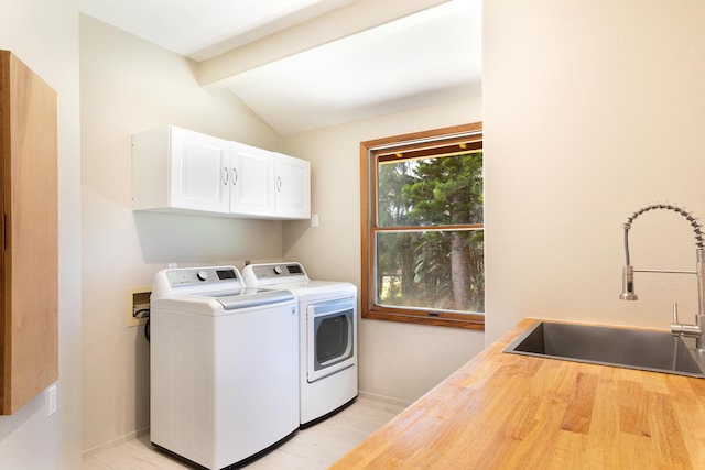 55-853 Kukini Pl, Hawi, HI 96719 - laundry area with cabinet space, washer and clothes dryer, baseboards, and light wood-style floors