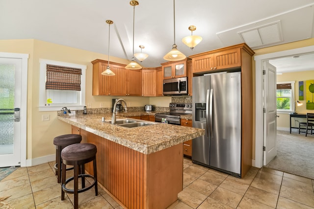 4771 Pepelani Lp Unit 1521, Princeville, HI 96722 - kitchen featuring appliances with stainless steel finishes, a sink, a peninsula, a breakfast bar, and baseboards