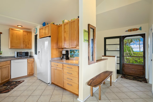 5451 Ka Haku Rd Unit 25, Princeville, HI 96722 - kitchen with white appliances, light tile patterned floors, and a towering ceiling