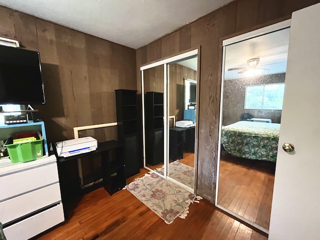 14-3473 Mauna Kea Rd, Pahoa, HI 96778 - bedroom featuring multiple closets, hardwood / wood-style floors, and wooden walls