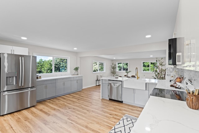 1577 Maunakai St, Hilo, HI 96720 - kitchen with appliances with stainless steel finishes, gray cabinetry, plenty of natural light, light stone countertops, and recessed lighting