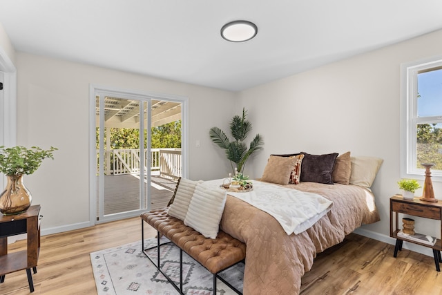 1577 Maunakai St, Hilo, HI 96720 - bedroom with access to outside, light wood-style flooring, and baseboards