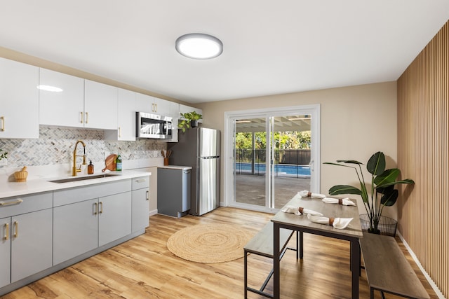 1577 Maunakai St, Hilo, HI 96720 - kitchen with a sink, stainless steel appliances, light countertops, and light wood-type flooring