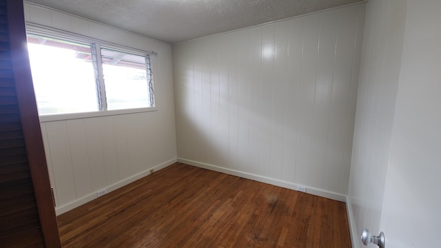 90 Palua Loop, Hilo, HI 96720 - empty room with wood finished floors, baseboards, and a textured ceiling