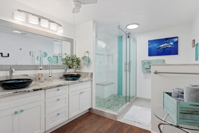 78-6842 Alii Dr Unit 11102, Kailua-Kona, HI 96740 - full bathroom with a shower stall, wood finished floors, ceiling fan, and double vanity